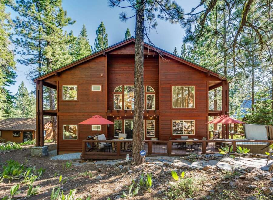Experience mountain living in this stunning wooden home nestled among tall pine trees.