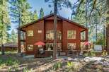 Experience mountain living in this stunning wooden home nestled among tall pine trees.