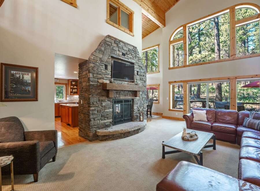 Experience luxury mountain living in this stunning home featuring a grand stone fireplace and soaring vaulted ceilings.