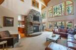 Experience luxury mountain living in this stunning home featuring a grand stone fireplace and soaring vaulted ceilings.