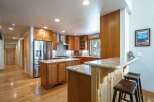 Discover this stunning kitchen featuring warm cherry wood cabinetry and a spacious island perfect for meal prep and casual dining.