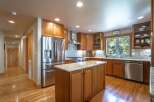 Experience the warmth of this inviting kitchen, featuring rich cherry wood cabinetry and a spacious granite-topped island perfect for meal prep and casual dining.