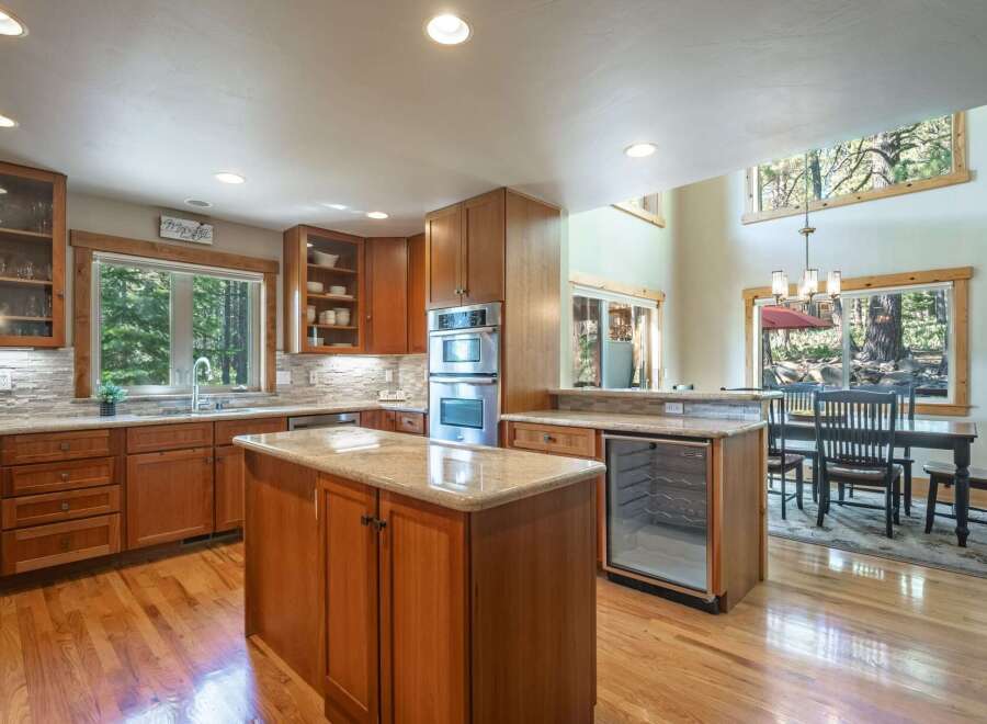 Discover this stunning kitchen featuring rich wood cabinetry and granite countertops, perfect for any home chef.