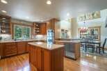 Discover this stunning kitchen featuring rich wood cabinetry and granite countertops, perfect for any home chef.