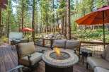 Experience outdoor living at its finest on this spacious deck, complete with a cozy fire pit and comfortable seating, perfect for gathering with loved ones.