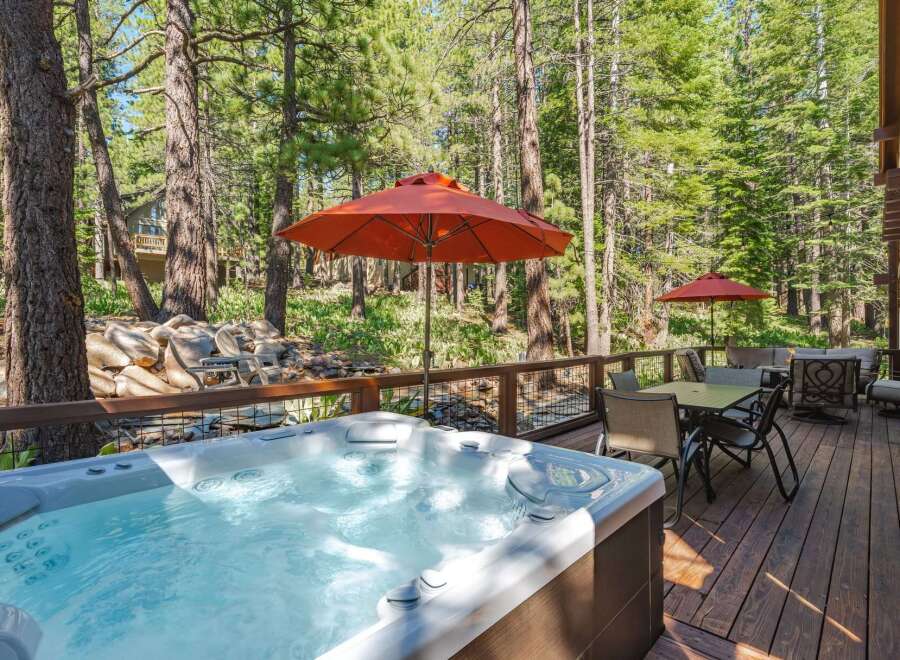 Experience ultimate relaxation in this stunning property featuring a luxurious hot tub perfect for unwinding amidst a serene forest setting.