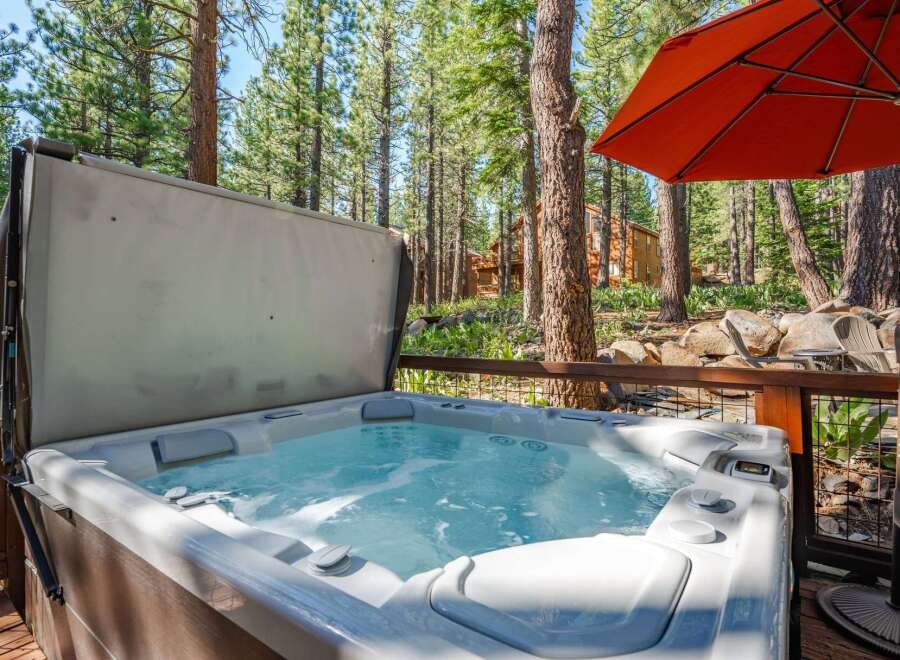Experience ultimate relaxation in this luxurious hot tub, nestled amidst a serene forest setting.