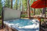 Experience ultimate relaxation in this luxurious hot tub, nestled amidst a serene forest setting.