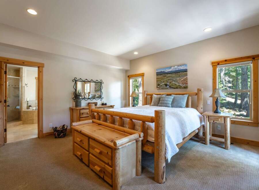 Experience rustic charm in this inviting bedroom, featuring a sturdy log bed and a convenient storage bench.