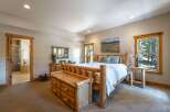 Experience rustic charm in this inviting bedroom, featuring a sturdy log bed and a convenient storage bench.