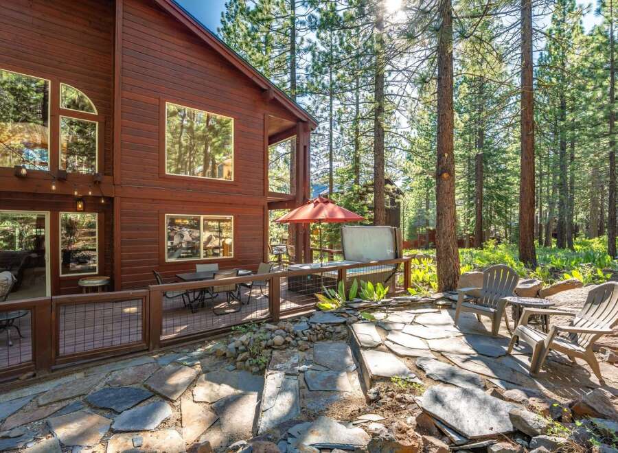 Experience the ultimate mountain retreat with this stunning wooden cabin nestled amongst tall pine trees.