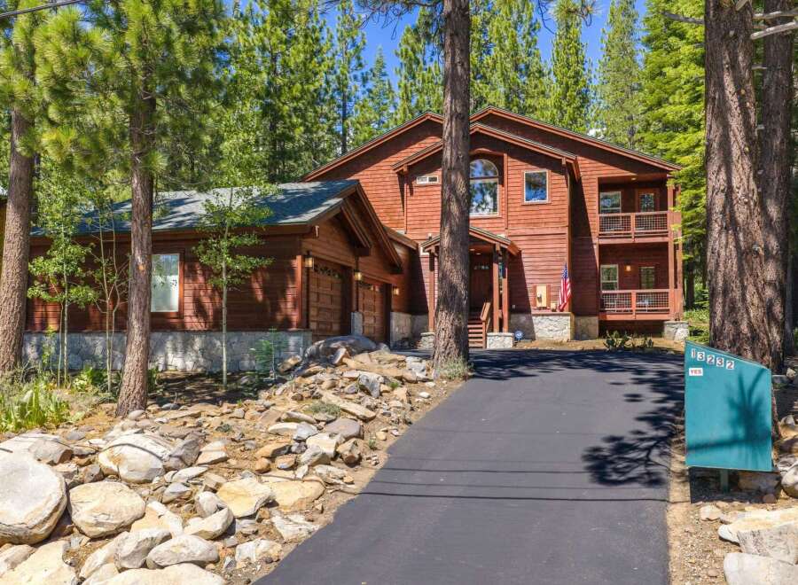 Nestled amidst towering pine trees, this stunning wooden home offers a serene mountain retreat.