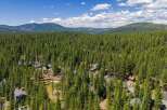 Nestled amidst a dense forest of towering pine trees, this property offers a serene and private retreat.