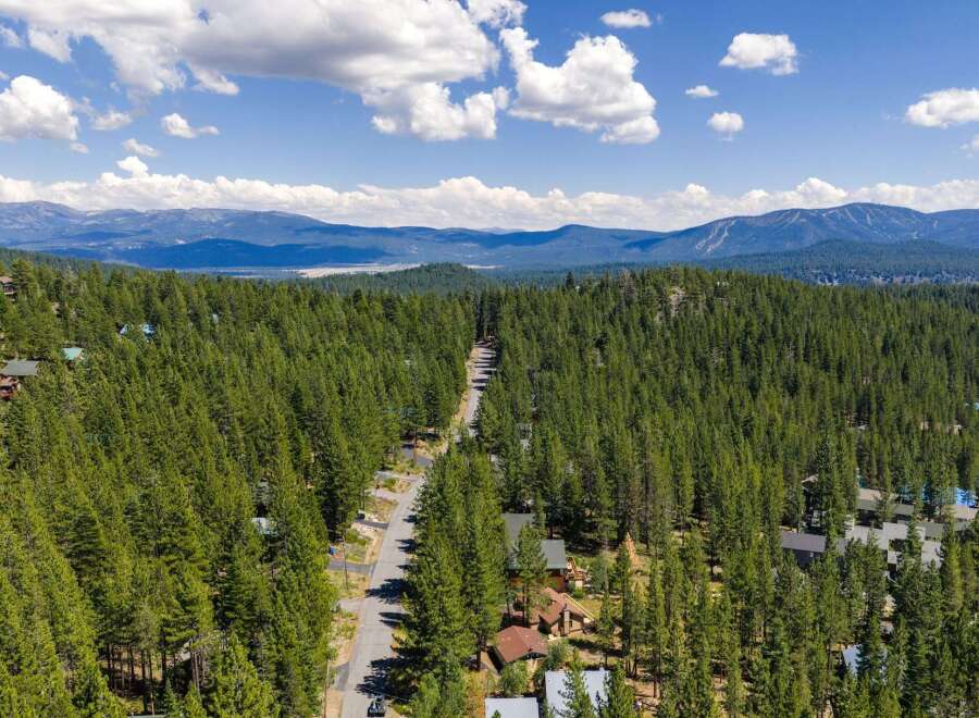 Nestled amidst a dense forest of towering pine trees, this property offers a secluded mountain retreat.