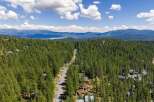 Nestled amidst a dense forest of towering pine trees, this property offers a secluded mountain retreat.