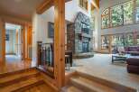 Experience rustic luxury in this stunning mountain home, featuring a grand stone fireplace as the centerpiece of the living area.