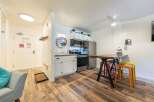 Discover this charming studio apartment featuring a compact yet functional kitchen with stainless steel appliances and ample cabinet space.