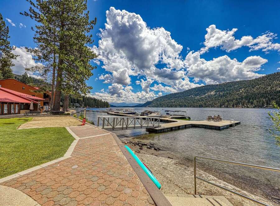 Experience lakeside living at its finest with this stunning property featuring a private dock and boat slips, perfect for water enthusiasts.