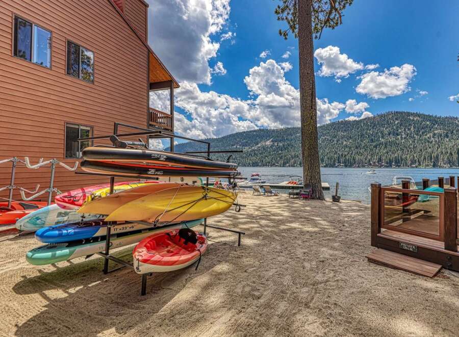 Enjoy lakeside living with this stunning property featuring a private beach and a variety of watercraft ready for adventure.