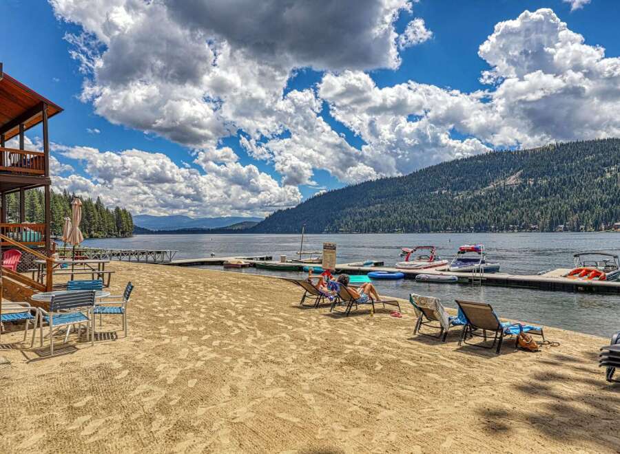 Enjoy lakeside living with this stunning property featuring a private beach and dock.