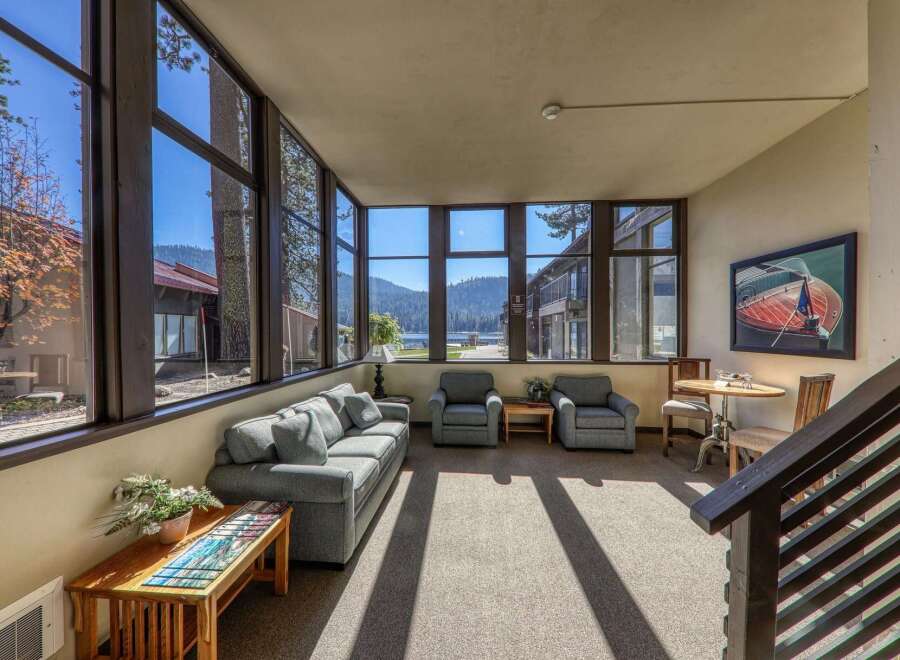 Enjoy breathtaking lake and mountain views from this spacious sunroom, perfect for relaxing or entertaining.