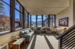 Enjoy breathtaking lake and mountain views from this spacious sunroom, perfect for relaxing or entertaining.