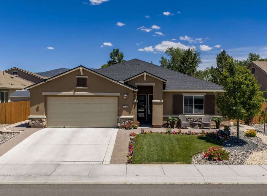 Discover this charming single-story home featuring a spacious two-car garage and an inviting front porch with seating areas.