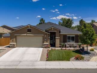 Discover this charming single-story home featuring a spacious two-car garage and an inviting front porch with seating areas.