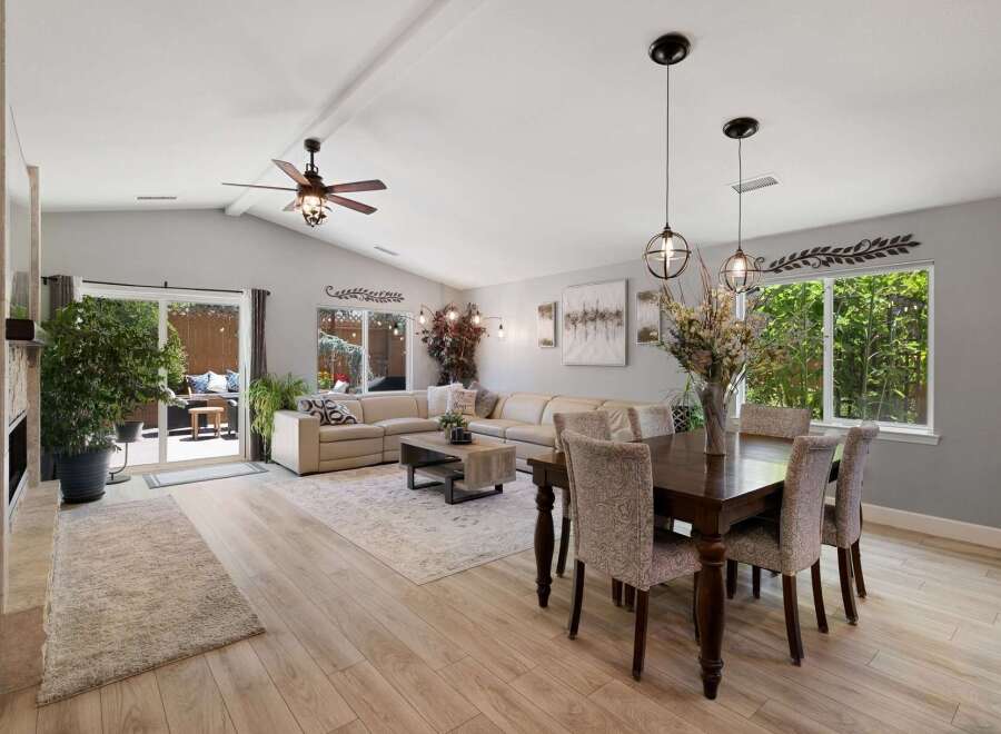 Experience spacious open-concept living in this beautifully appointed home, featuring a large sectional sofa perfect for gatherings.