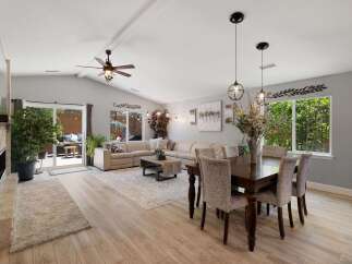 Experience spacious open-concept living in this beautifully appointed home, featuring a large sectional sofa perfect for gatherings.
