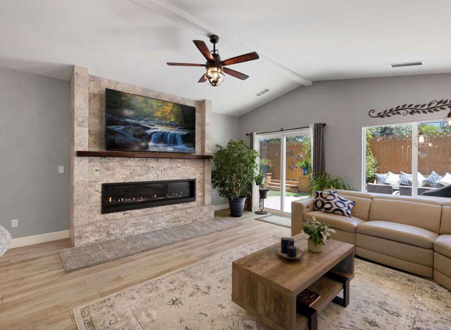 Experience modern living in this stunning living room, featuring a sleek linear fireplace and a large, mounted television perfect for entertainment.