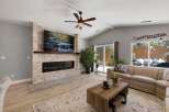 Experience modern living in this stunning living room, featuring a sleek linear fireplace and a large, mounted television perfect for entertainment.