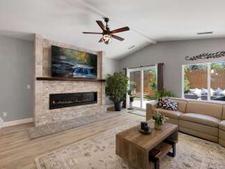 Experience modern living in this stunning living room, featuring a sleek linear fireplace and a large, mounted television perfect for entertainment.