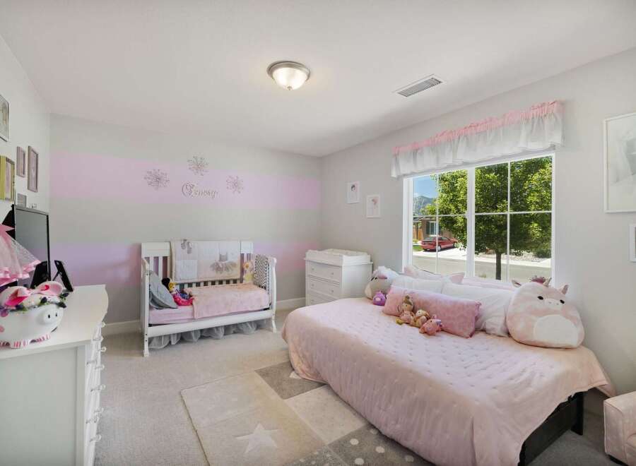 This charming nursery features a convertible crib and a twin bed, perfect for a growing child.
