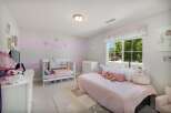 This charming nursery features a convertible crib and a twin bed, perfect for a growing child.