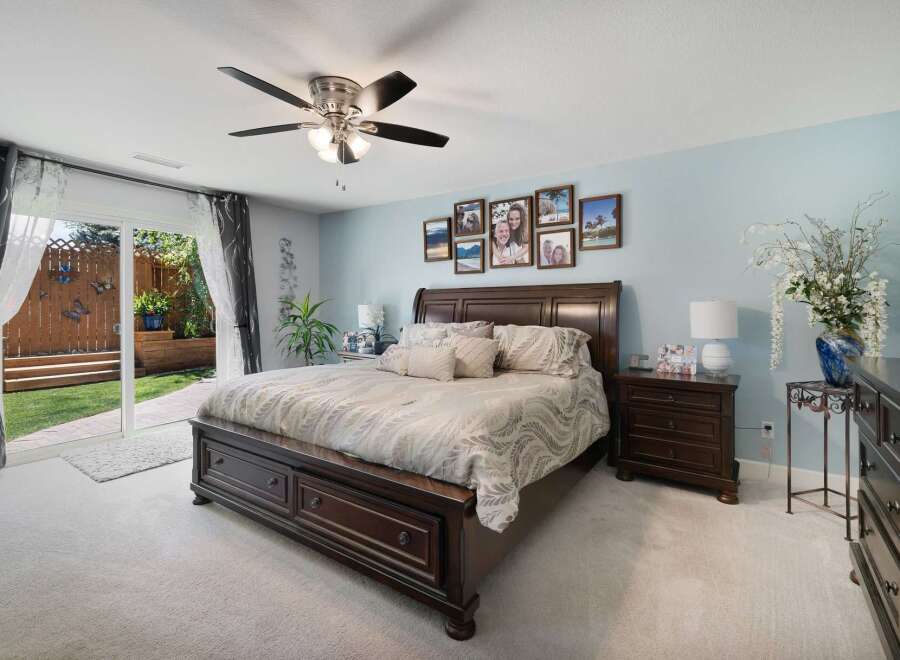 Experience luxurious comfort in this master bedroom, featuring a spacious king-size bed with elegant bedding and a rich, dark wood frame.