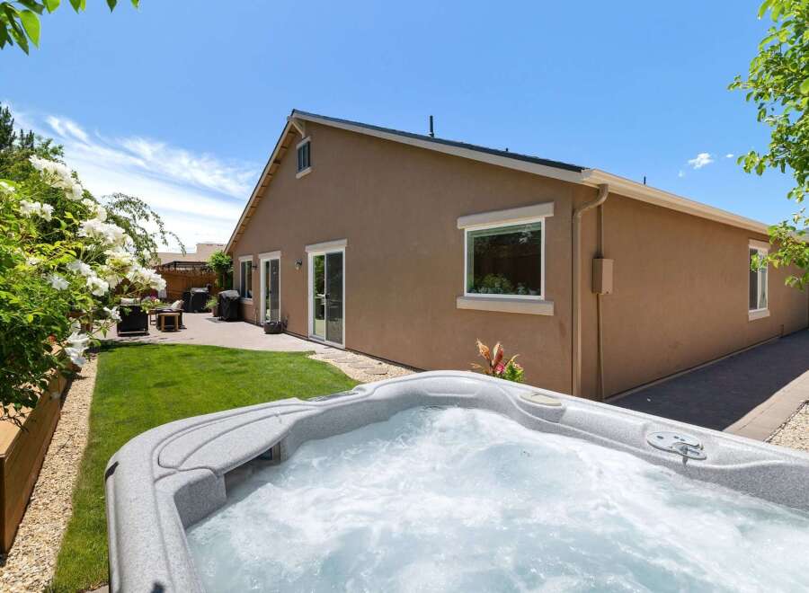 Enjoy ultimate relaxation in this backyard oasis, featuring a bubbling hot tub perfect for unwinding after a long day.