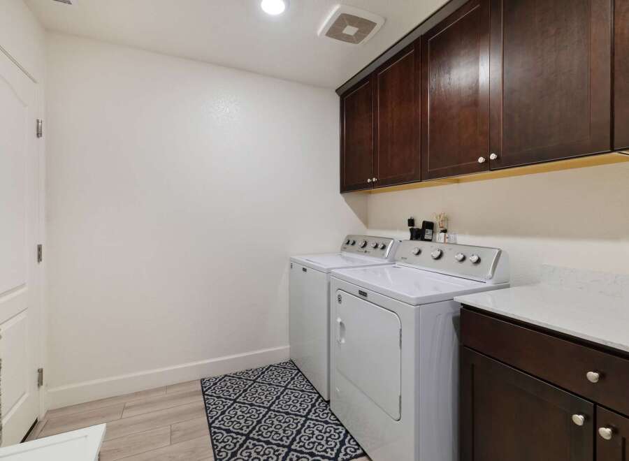 This laundry room features a convenient side-by-side washer and dryer set, perfect for efficient chore management.