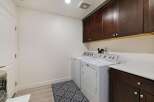 This laundry room features a convenient side-by-side washer and dryer set, perfect for efficient chore management.