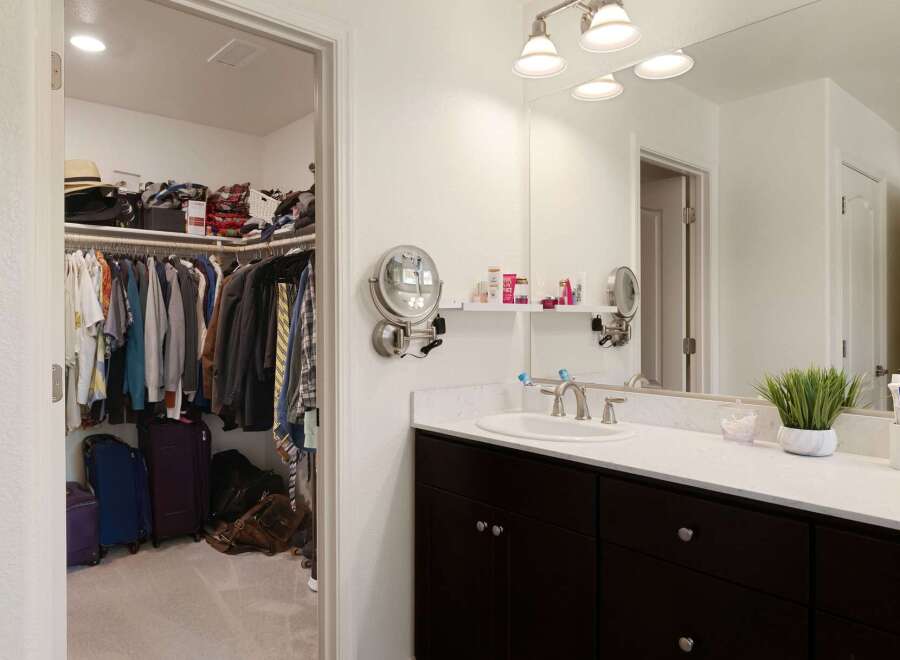 Step into this spacious master suite featuring a large walk-in closet with ample storage for all your clothing and accessories.