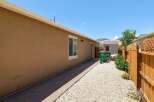 Discover this charming property featuring a well-maintained backyard with a paved walkway and gravel landscaping.