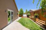 Enjoy outdoor living in this beautifully landscaped backyard featuring a relaxing hot tub perfect for unwinding.