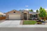 This charming single-family home features a welcoming facade with a neutral-toned stucco exterior and stone accents.