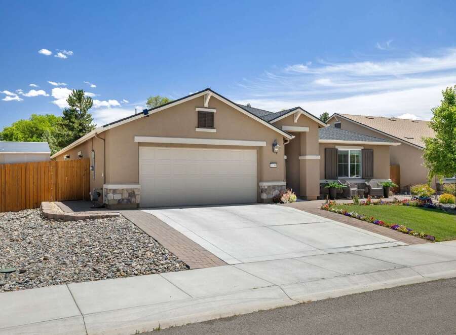 Discover this charming single-story home featuring a spacious three-car garage and a welcoming facade.
