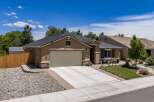 Discover this charming single-story home featuring a welcoming facade with stone accents and a spacious driveway leading to an attached garage.