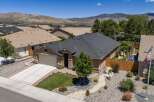 Discover this charming single-family home featuring a spacious two-car garage and a beautifully landscaped front yard with vibrant flowers and a lush green lawn.