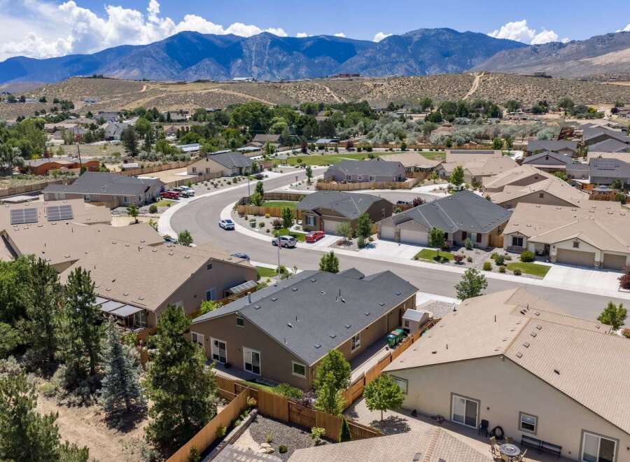 Discover this stunning suburban neighborhood with modern homes nestled against a backdrop of majestic mountains.