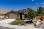 Discover this charming single-story home featuring a well-maintained lawn and vibrant flower beds.