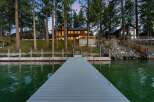 Experience luxury lakeside living with this stunning property featuring a modern dock extending into the serene waters.