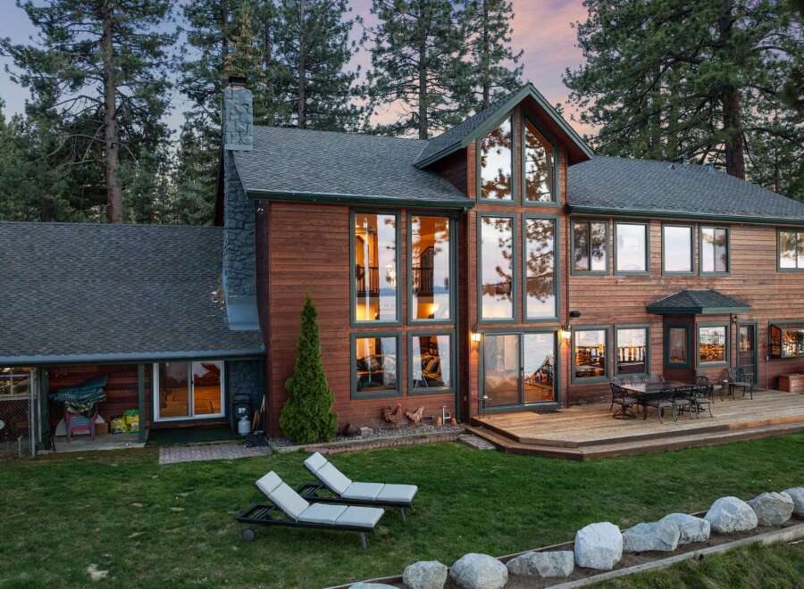 Experience luxury living in this stunning lakefront home, boasting expansive windows that offer breathtaking water views and abundant natural light.